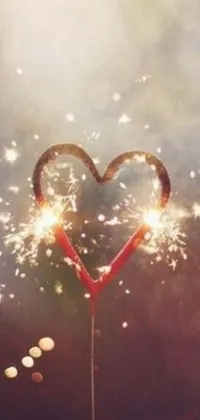 Looking for a romantic and colorful live wallpaper for your phone? Check out this wallpaper with a heart-shaped sparkler emitting bright and vibrant colors that move and float upwards