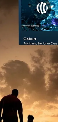 This phone live wallpaper displays a couple standing on a beach, overlooking calm waters during sunset