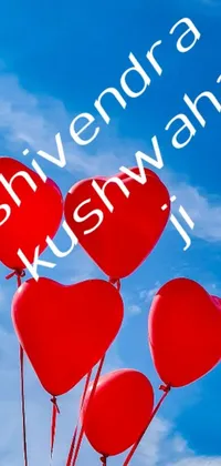 This live phone wallpaper showcases a delightful design of red heart-shaped balloons in a clear blue sky