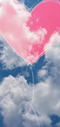 This phone live wallpaper showcases a charming pink heart-shaped balloon flying amidst cotton candy clouds against a serene blue sky