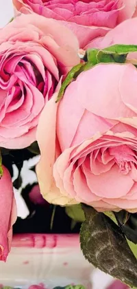 This stunning phone live wallpaper features a vase filled with vibrant pink roses