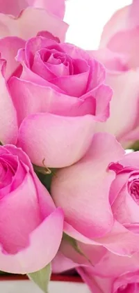 This phone live wallpaper showcases a zoomed in view of a vase filled with delicate pink roses