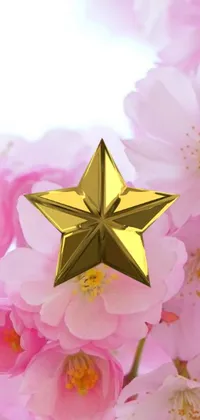 This stunning live wallpaper showcases a gleaming gold star delicately perched upon a bed of vibrant pink flowers, creating an elegant and luxurious aesthetic