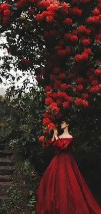 This stunning live wallpaper showcases a woman dressed in vibrant red velvet standing beneath a flowering tree