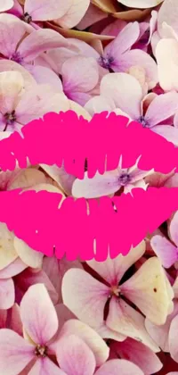 Looking for a romantic and playful phone wallpaper? Check out this stunning image inspired by romanticism and featuring a close-up of a pink lipstick on a bed of flowers