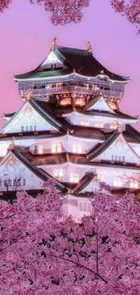 This live wallpaper for phones displays a large white building surrounded by pink flowers and beautiful Japanese elements such as a cherry blossom tree and a samurai sword