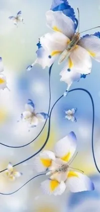 This stunning live wallpaper features a mesmerizing painting of blue and white flowers and butterflies, surrounded by yellow and blue ribbons