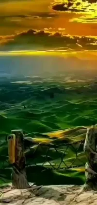 This phone live wallpaper showcases a stunning digital painting featuring wooden posts on a hill, alongside fields of green and a beautiful sunset in the valley