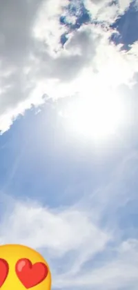 This phone live wallpaper features a cheerful smiley face balloon soaring through the sky