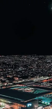 This phone live wallpaper showcases the awe-inspiring aerial view of a city at night, with the moon shining bright and illuminating the entire scene