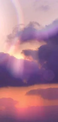 This stunning live wallpaper features a serene sunset scene with a majestic lighthouse, vibrant rainbow, and soft purple glow