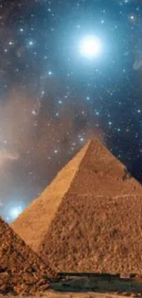 This phone live wallpaper features a stunning depiction of three Egyptian pyramids adorned with hieroglyphics and hermetic symbols against a backdrop of galaxies and stars