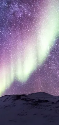 This stunning phone live wallpaper depicts a picturesque snow-covered field with a bright yellow tent surrounded by beautiful northern lights shimmering in purple and green colors above the vast expanse of space