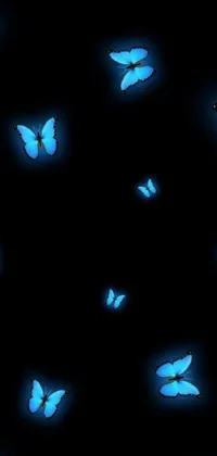 This stunning phone live wallpaper features a group of blue butterflies fluttering through a nocturnal sky against a black backdrop