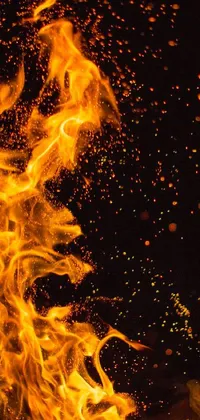 This live wallpaper for your phone features a stunning close-up of a fiery blaze on a sleek black background