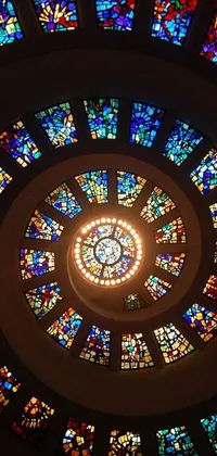 This phone live wallpaper features a circular stained glass window in a church, with stunning details and vibrant colors