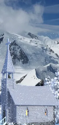 The phone live wallpaper depicts a breathtaking snow-covered landscape featuring a beautiful church and towering trees