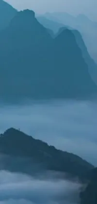This live wallpaper depicts a picturesque mountain scenery in Laos that showcases a group of people standing on its summit
