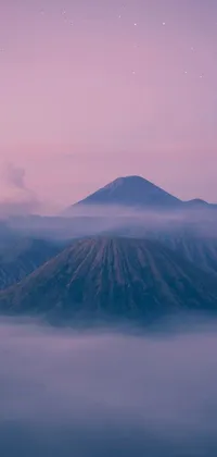 This phone live wallpaper depicts a beautiful mountain, emitting a plume of smoke from its summit