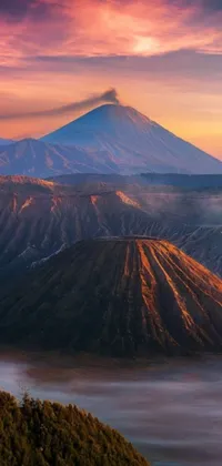 This phone live wallpaper presents a picturesque view of a towering volcano from the peak of a mountain