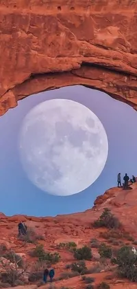 Looking for a beautifully crafted phone live wallpaper? Check out this stunning design—a glowing full moon captured through a small window in a rocky arch
