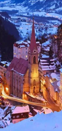 This live phone wallpaper features a beautiful romanesque church situated amidst a snowy town