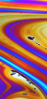 This live wallpaper for your phone displays a detailed image of a close-up liquid substance with intricate patterns and retro-style oil lines