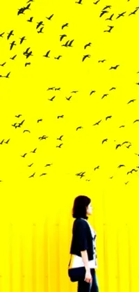 This phone live wallpaper boasts a mesmerizing digital art piece that features a woman embracing a flock of birds in a postminimalist style