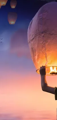 This live wallpaper depicts a breathtaking scene with a sky lantern held high above