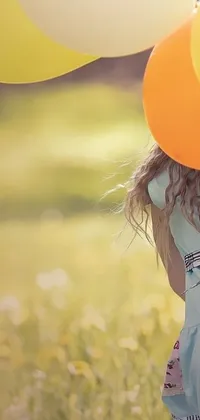 This live wallpaper features an adorable little girl holding balloons in a meadow