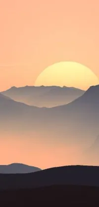 This phone live wallpaper features a stunning sunset over an awe-inspiring mountain range