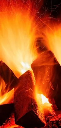 This live wallpaper showcases an eye-catching image of rocks stacked atop a blazing fire