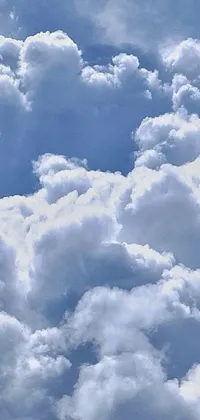 Looking for a captivating live wallpaper for your phone? Check out this charming design featuring a vintage propeller plane soaring through a blue sky filled with fluffy cumulus clouds