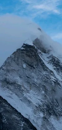 This stunning phone live wallpaper features a majestic mountain covered in snow and clouds, offering a breathtaking view of Nepal's natural beauty