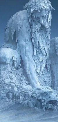 This phone live wallpaper features a stunning statue of a man seated on a snow-capped mountain