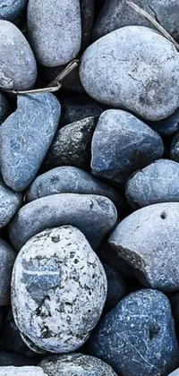This live wallpaper showcases a pile of rocks made of stone in a closeup blueish display, creating a calming and soothing atmosphere