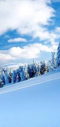 Experience the thrill of skiing down a snowy hill with this stunning phone live wallpaper