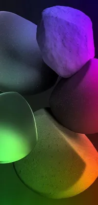 This mobile live wallpaper features a stunning 3D representation of stacked rocks illuminated by rainbow lighting