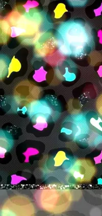 This live phone wallpaper features a vibrant leopard print on a black background incorporating bright and bold patterns and shapes, blending colors of turquoise, pink and yellow for a playful and unique design