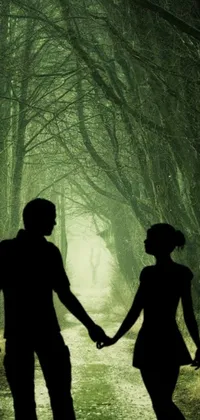 Looking for a stunning live phone wallpaper that will transport you to a lush green forest? Look no further than this beautifully edited silhouette of a man and woman holding hands, evoking a sense of romance and adventure