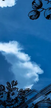 This phone live wallpaper features a striking clock display set on the side of a building, set against a smoky blue background with a whorl of clouds emanating from the clock