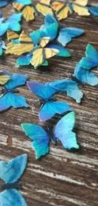 This live wallpaper is a stunning mix of blue and yellow butterflies, airbrush painting, unsplash, cloisonnism, paper decoration, bokeh and iridescent accents