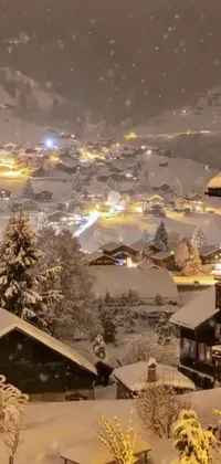 This phone live wallpaper portrays a picturesque mountain village covered in snow