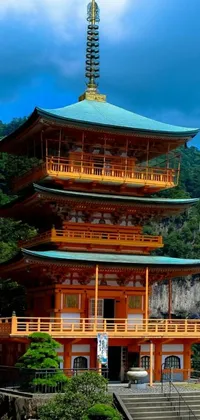 This phone live wallpaper captures the serene beauty of a pagoda surrounded by a lush landscape