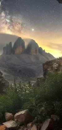 This live wallpaper showcases a stunning view of the night sky from inside a cave in the dolomites