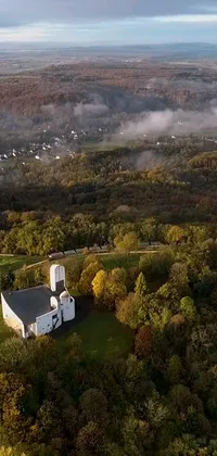 This phone live wallpaper features an aerial view of a church surrounded by trees in West Virginia