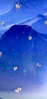 This phone live wallpaper is a mesmerizing digital art of a mountain surrounded by beautiful butterflies