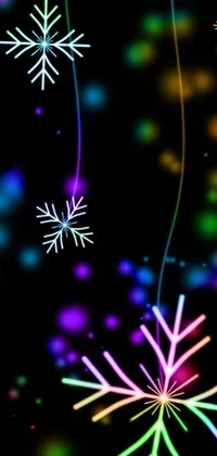 This phone live wallpaper features a colorful and adorable display of snowflakes set against a sleek black background