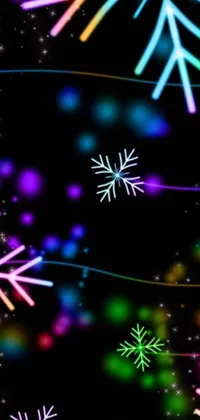 Bring the winter wonderland to your phone with this mesmerizing live wallpaper! Featuring a beautiful digital art display of snowflakes gracefully falling on a black background, illuminated by intricate tendrils of colorful light