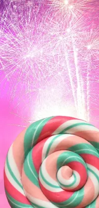 This live wallpaper features a colorful and playful close up of a lollipop with bursts of fireworks in the background